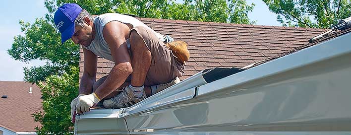 Princeton Gutters worker installing seamless gutter guards